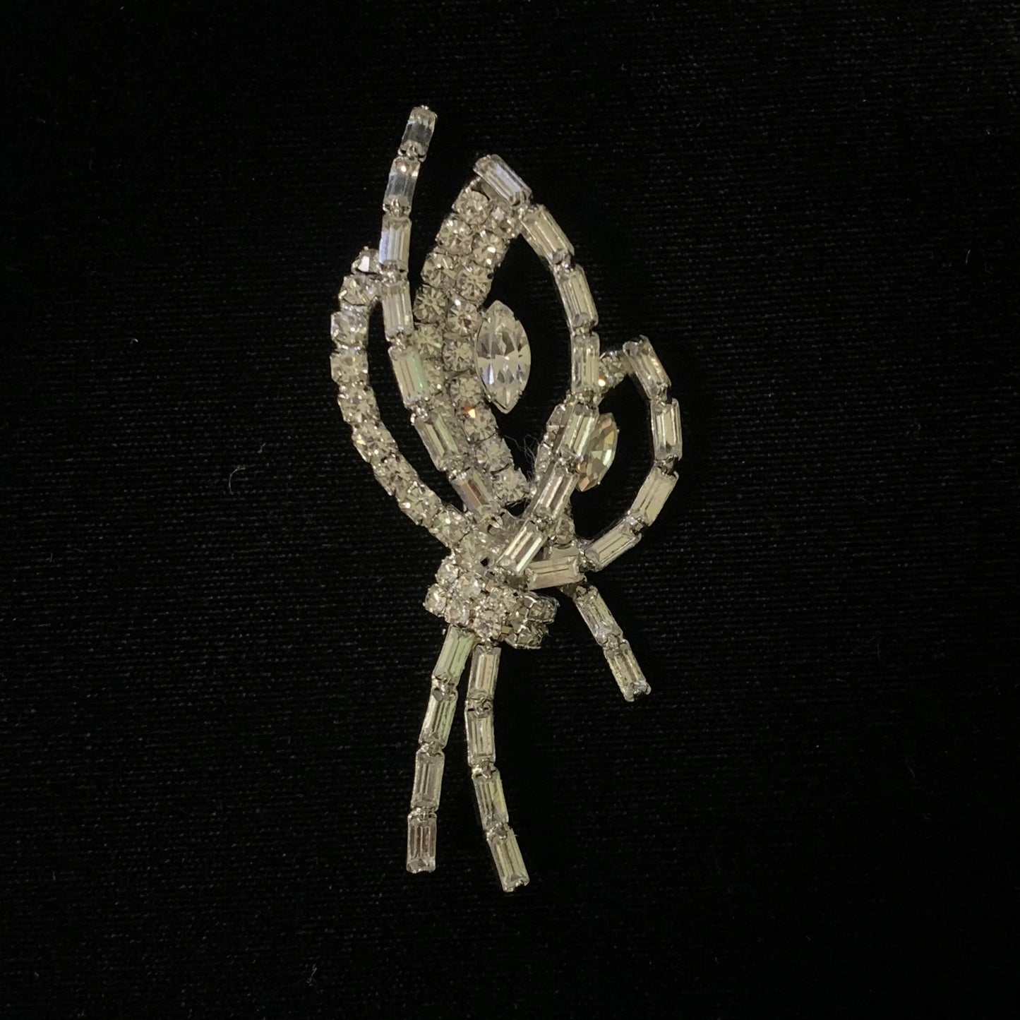 Decorative brooch with crystal-like elements on a black background