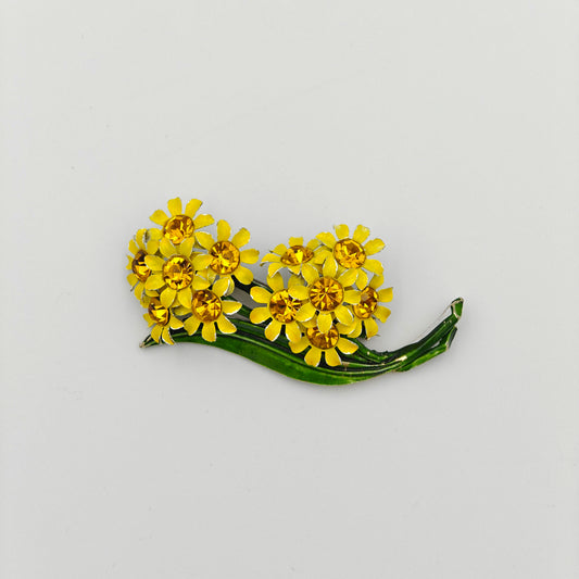 Floral brooch with yellow flowers on a white background